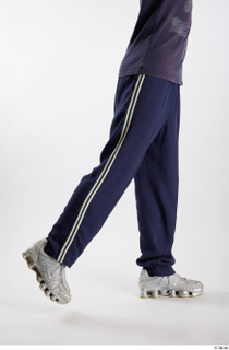 Urien  1 blue track pants dressed flexing leg side…